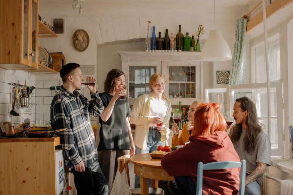 people standing and sitting in front of table